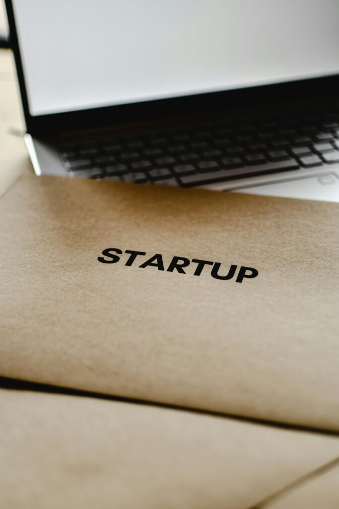 Close-up of a startup folder and laptop, representing business and technology innovation.